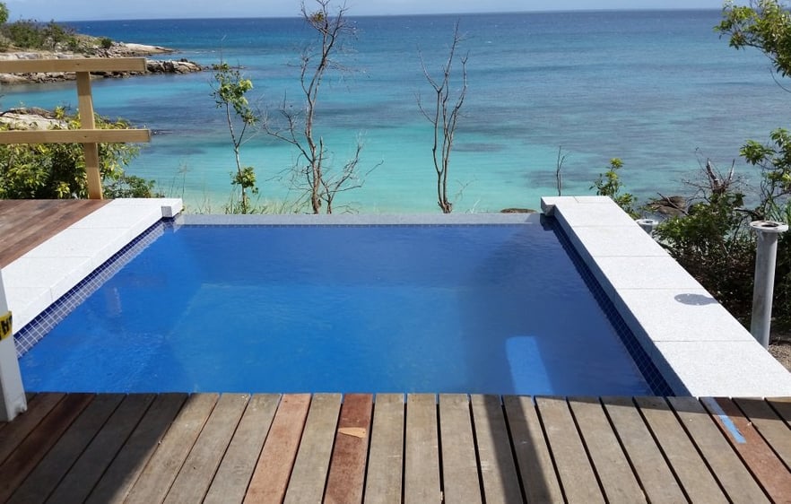 fibreglass infinity edge pool looking out at the beach