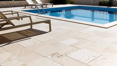 Light coloured travertine tiles surrounding a fibreglass diy pool 